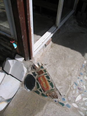 the entry into a cabin semi precious stones laid in the concrete of the sun room and enterance of our home.